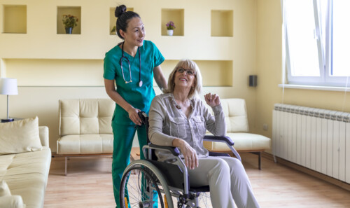 Disabled Older Woman and Female Caregiver are Spending Time Together at Home.