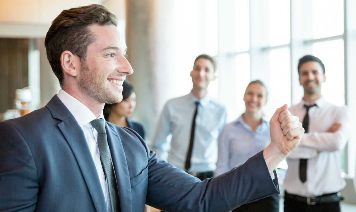 Cheerful leader motivating his business team