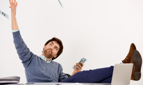 Confused businessman sitting at the office desk