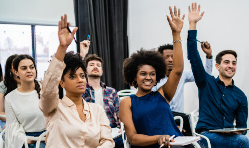 Group of young people sitting on conference together.